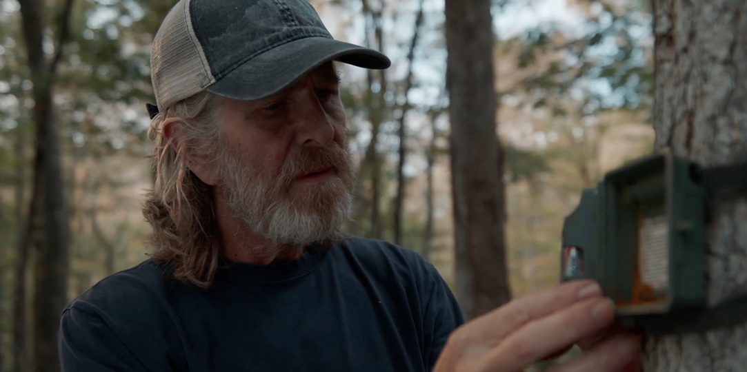 Cal checks the damaged trail cam